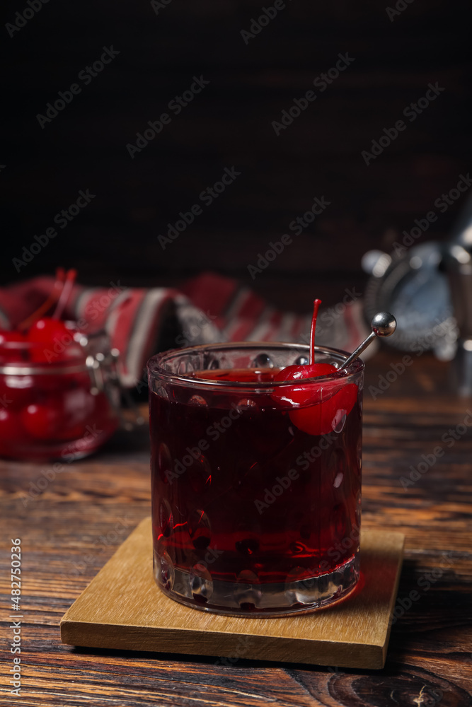 Glass of tasty Manhattan cocktail on table