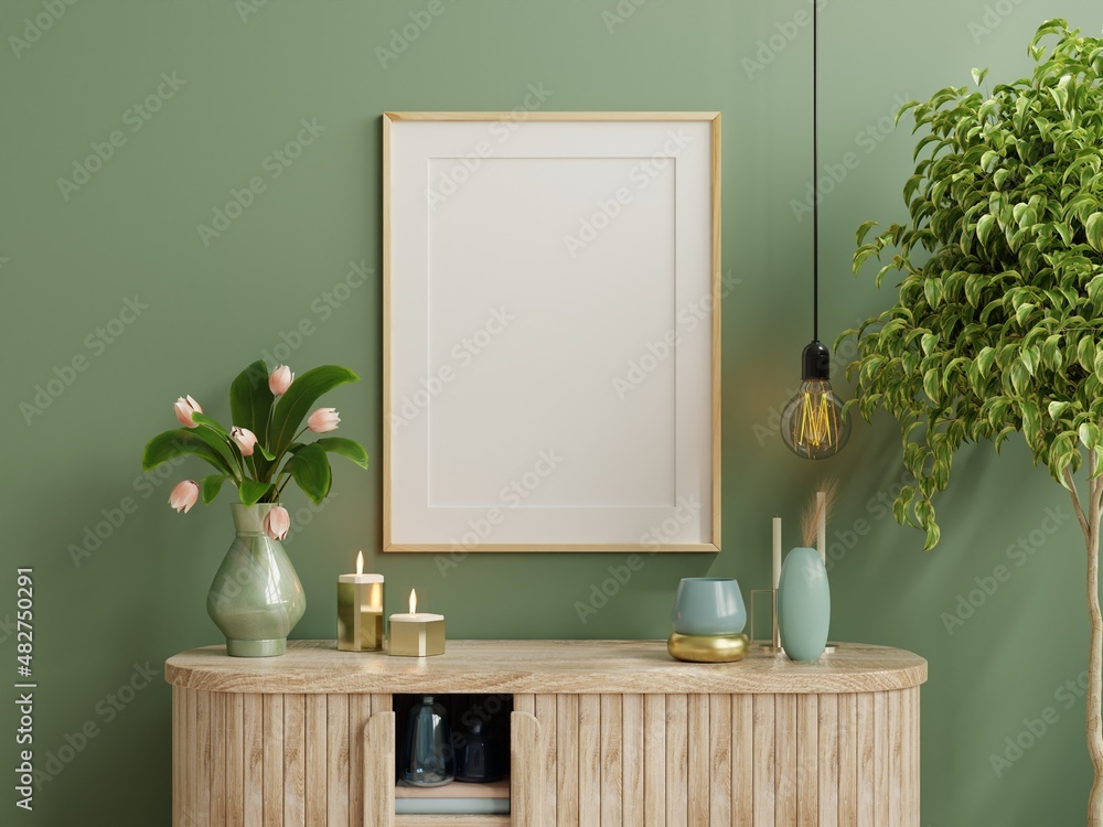 Mock up photo frame green wall mounted on the wooden cabinet with beautiful plants.