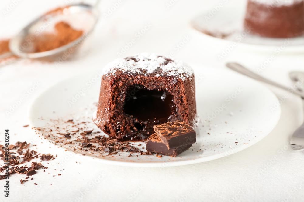 Plate with tasty lava cake fondant on light background, closeup