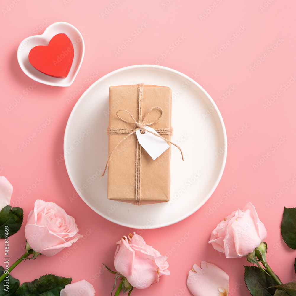 Valentines Day gift and meal design concept background with pink rose flower on pink background.