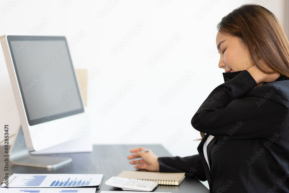 A business woman has a pain in the nape of her neck. Woman with neck pain from hard work doing stret