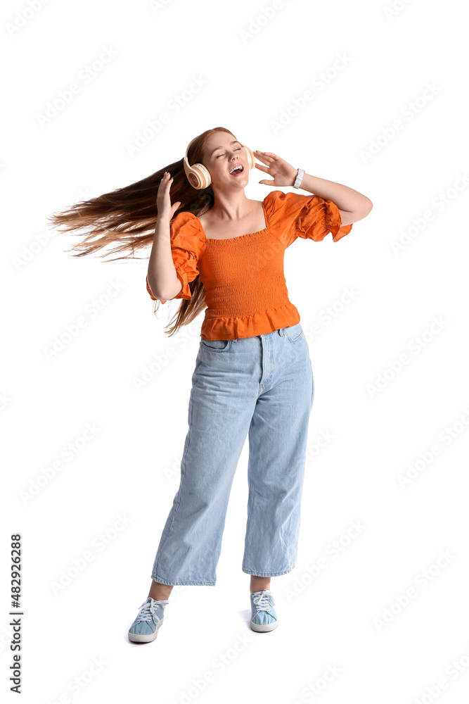 Cool young woman listening to music on white background