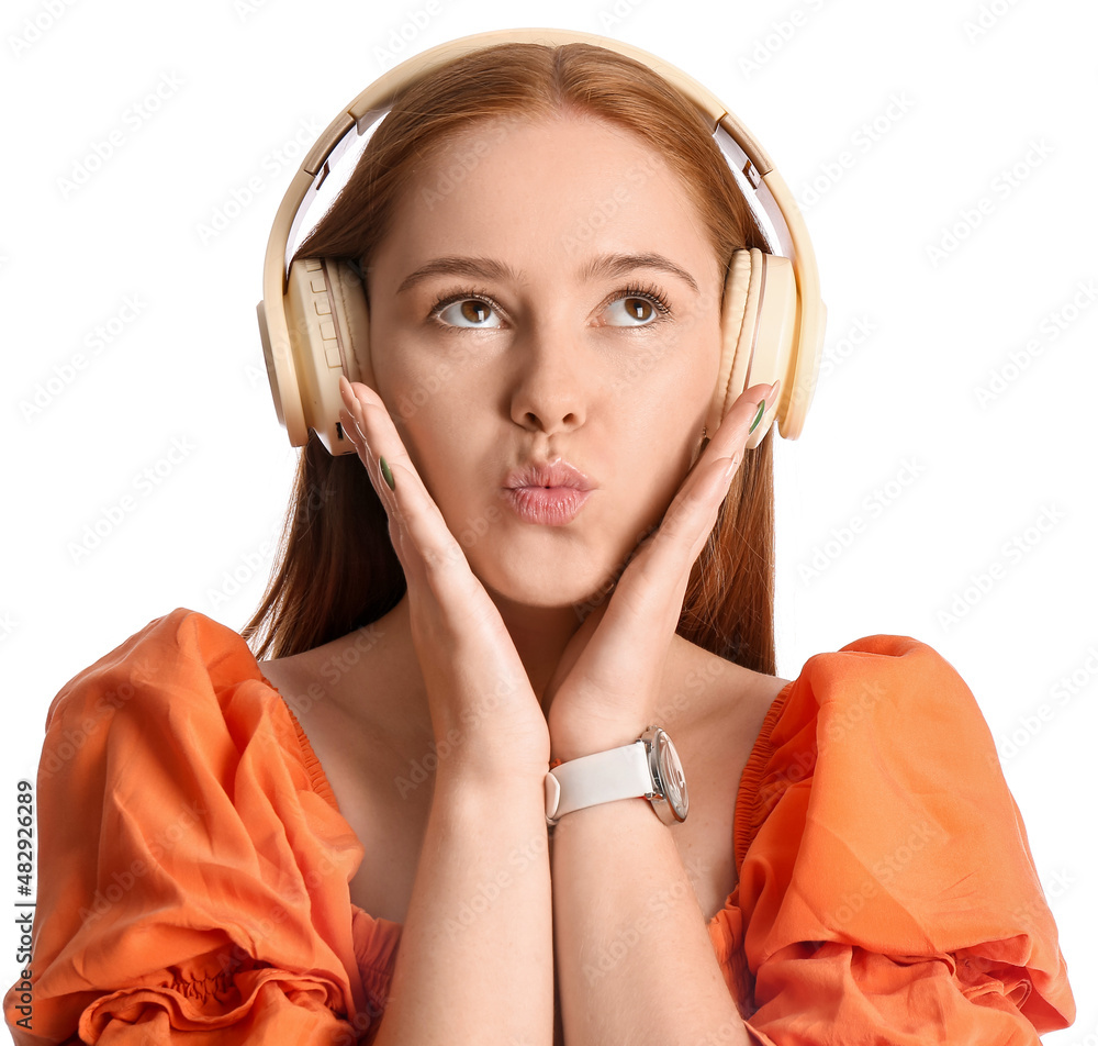 Cool young woman listening to music on white background