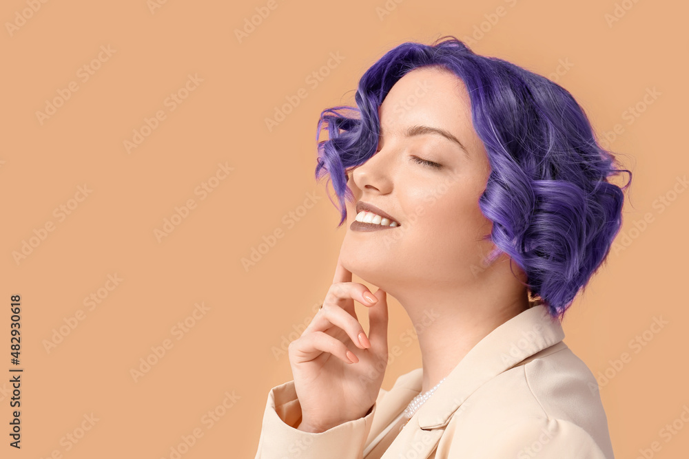 Beautiful young woman with violet hair on color background. Very Peri - color of year 2022