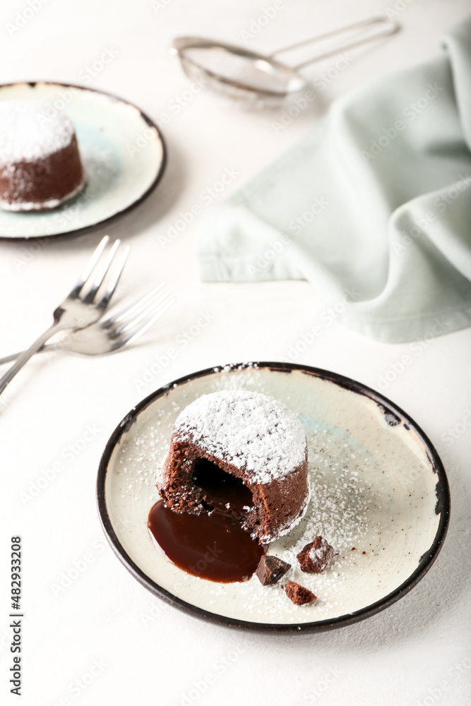 Plate with tasty lava cake fondant on white background