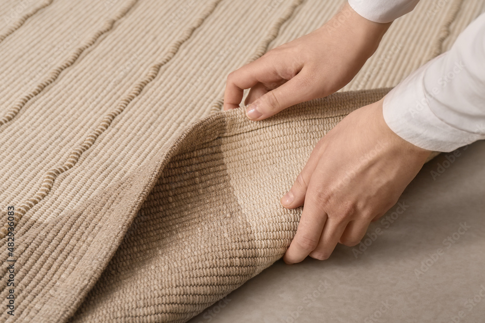 Woman with stylish carpet at home, closeup