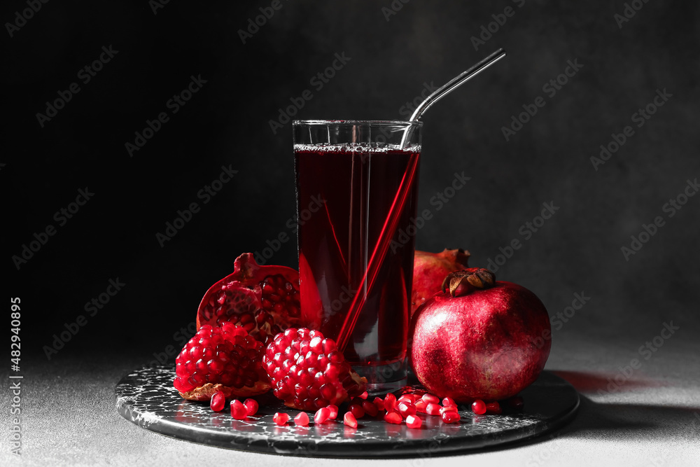 Glass of delicious pomegranate juice on table