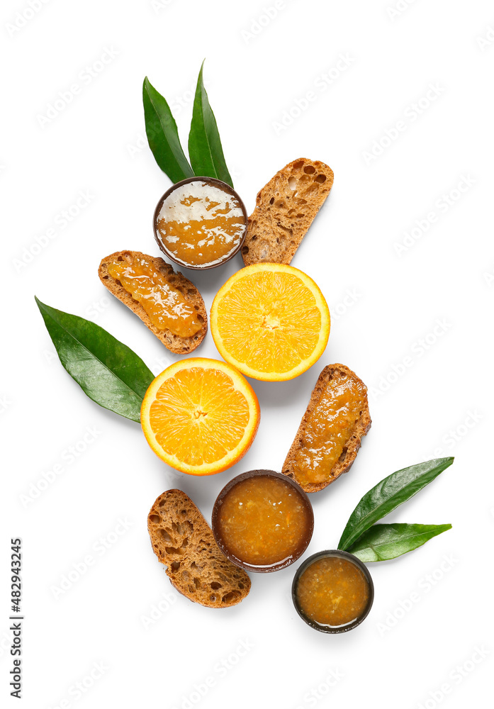 Composition with tasty orange jam and bread on white background