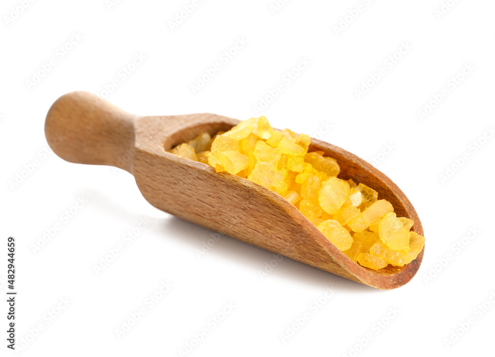 Wooden scoop with orange sea salt on white background