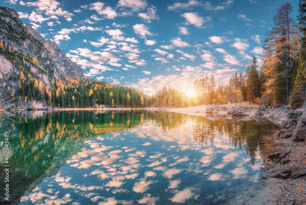 Beautiful Braies lake at sunset in autumn in Dolomites, Italy. Landscape with mountains, blue sky wi