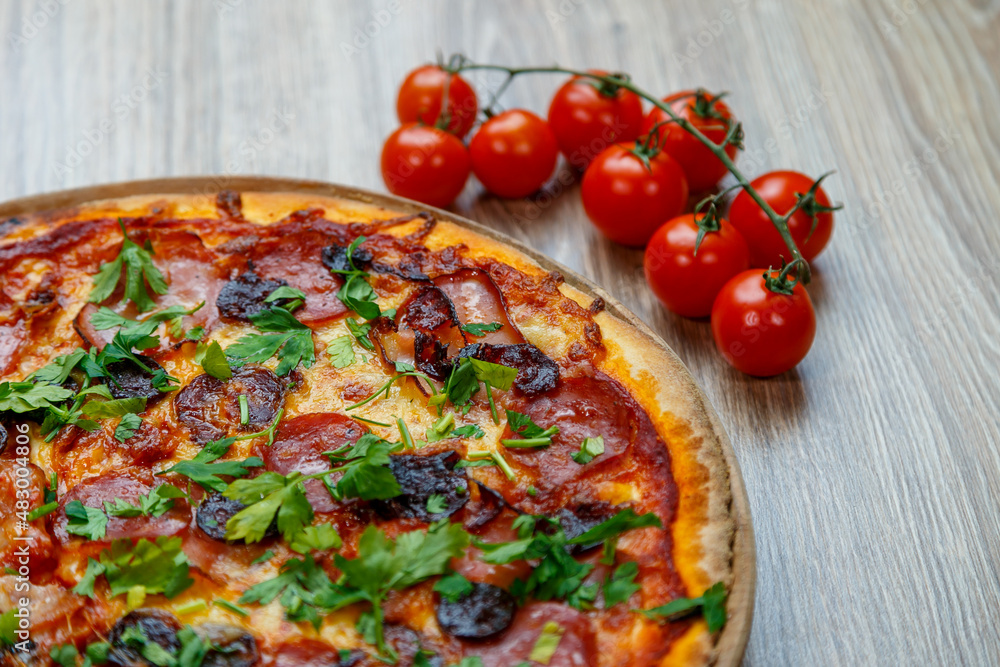 pizza with sausage, salami, chesse and parsley