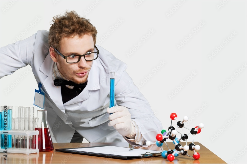 Funny laboratory worker checks analysis holds glass and tube conducts chemical research