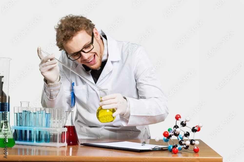 Funny laboratory worker checks analysis holds glass and tube conducts chemical research