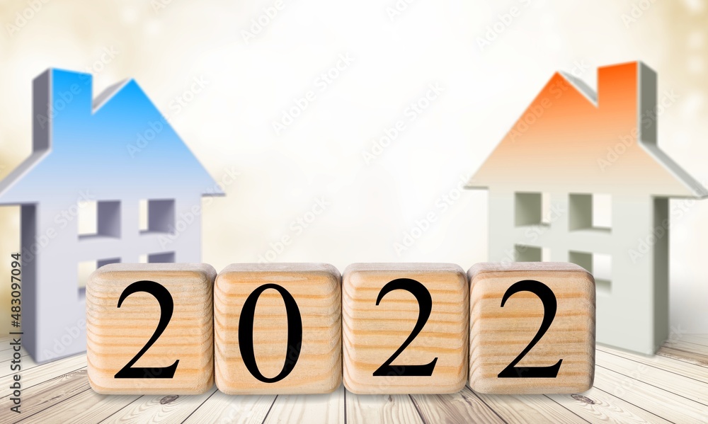 Two house model and 2022 wooden blocks number. New year property investment concept.