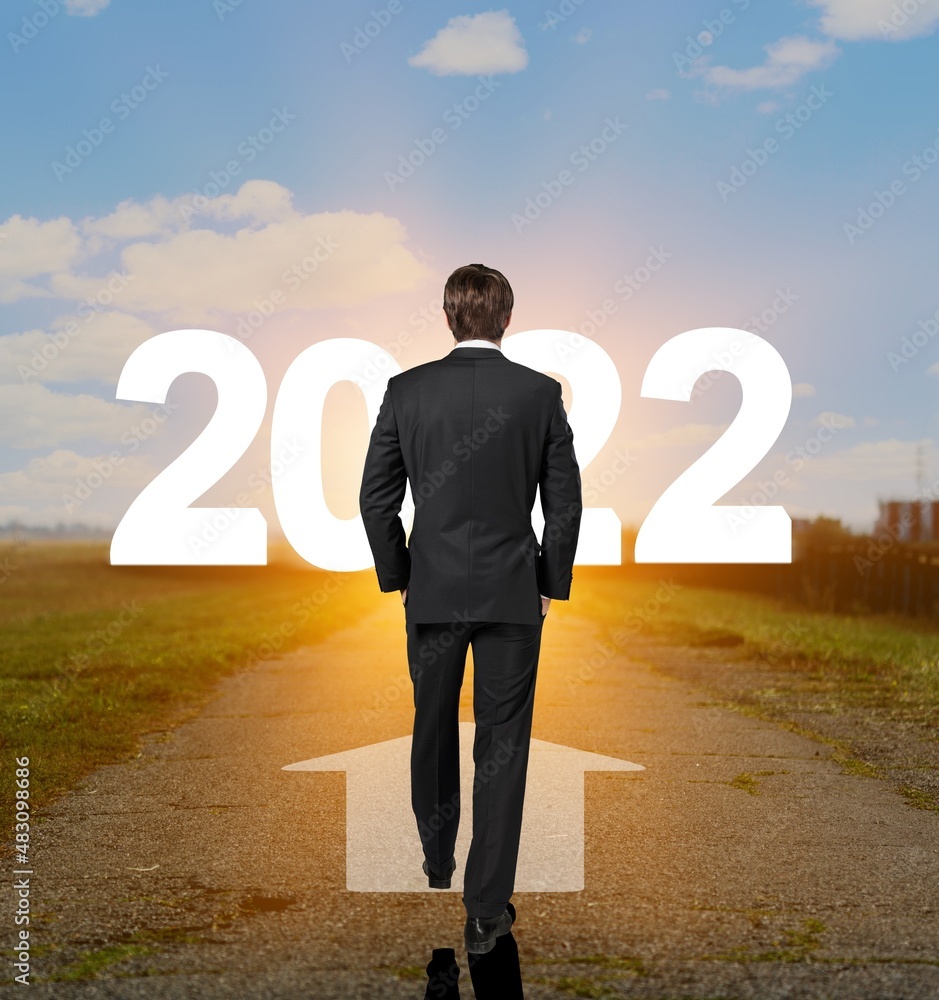 The 2022 New Year journey and future vision concept. Businessman traveling on highway road