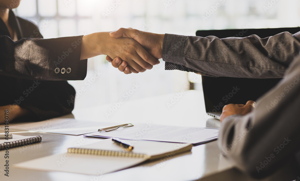 Businessman shaking hands with colleagues after the job interview is over.