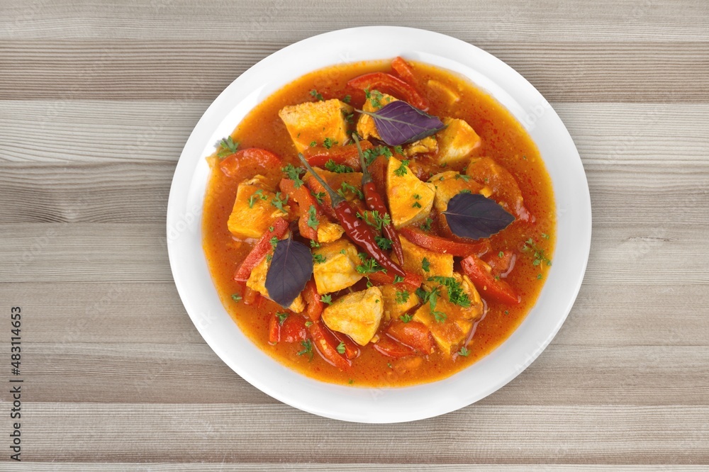 Thai dish with chicken, eggs, spicy, curry paste, tomatoes in a bowl