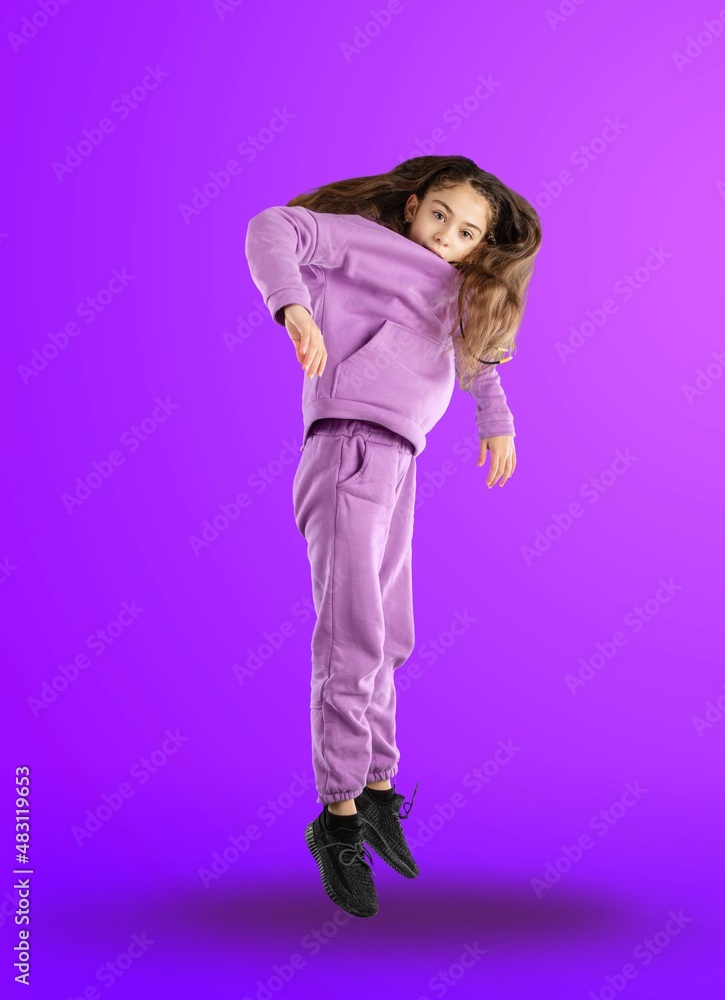 Full length portrait of a stylish girl posing at studio on a background. Youth style.