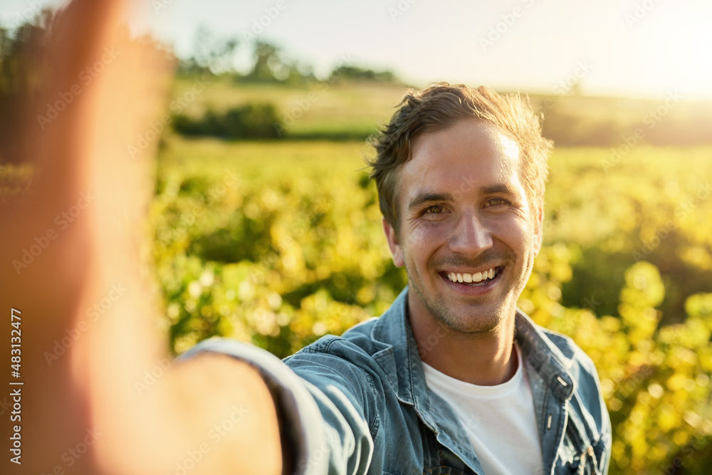 Time to get my harvest on. Shot of a young man taking a selfie while working on a farm.