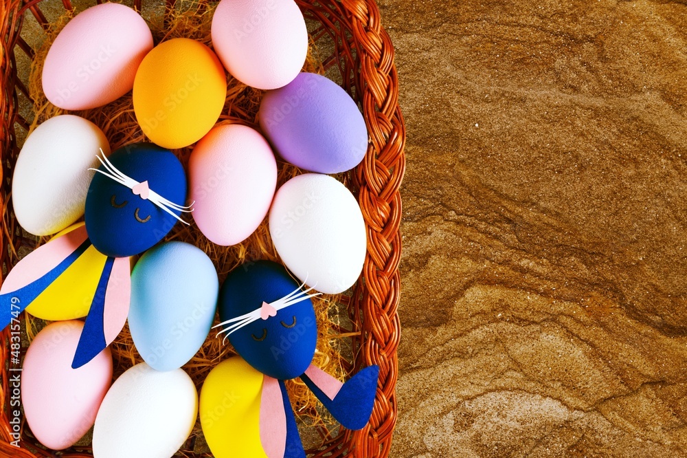 Traditional colored easter eggs in wooden basket