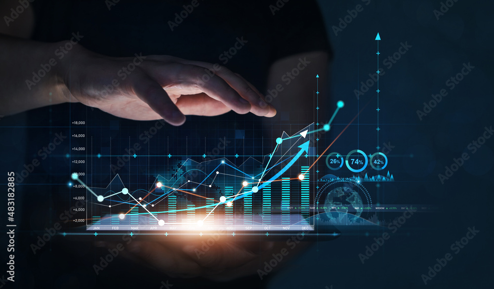 Businessman holding tablet with growing virtual hologram of statistics. Business planning and strate