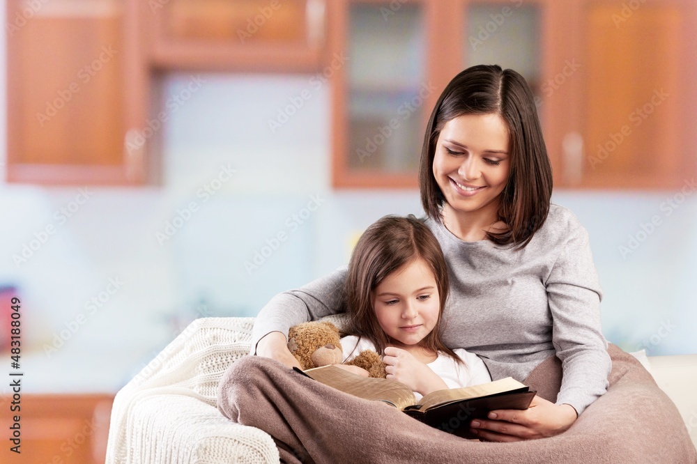 Mom woman with baby girl helper read cookbook