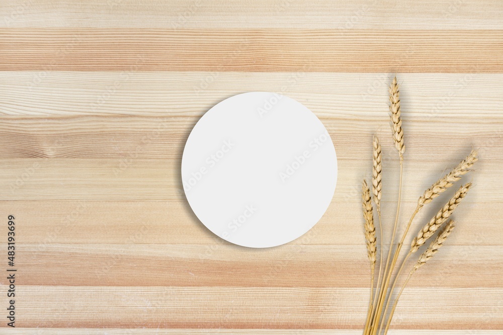 Empty round podium and bouquet of dry oats on the desk