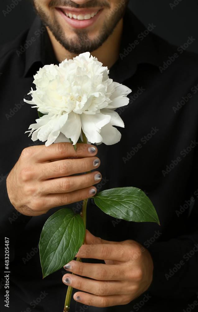 Smiling man with trendy manicure holding beautiful flower, closeup