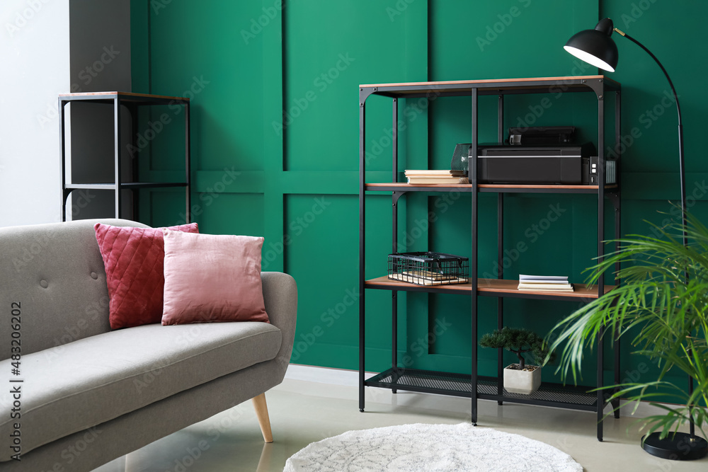 Interior of modern room with shelf unit and comfortable sofa