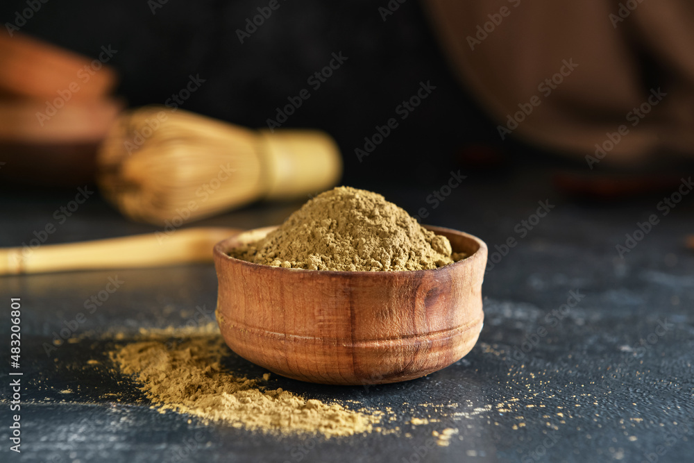 Bowl with hojicha powder on black background