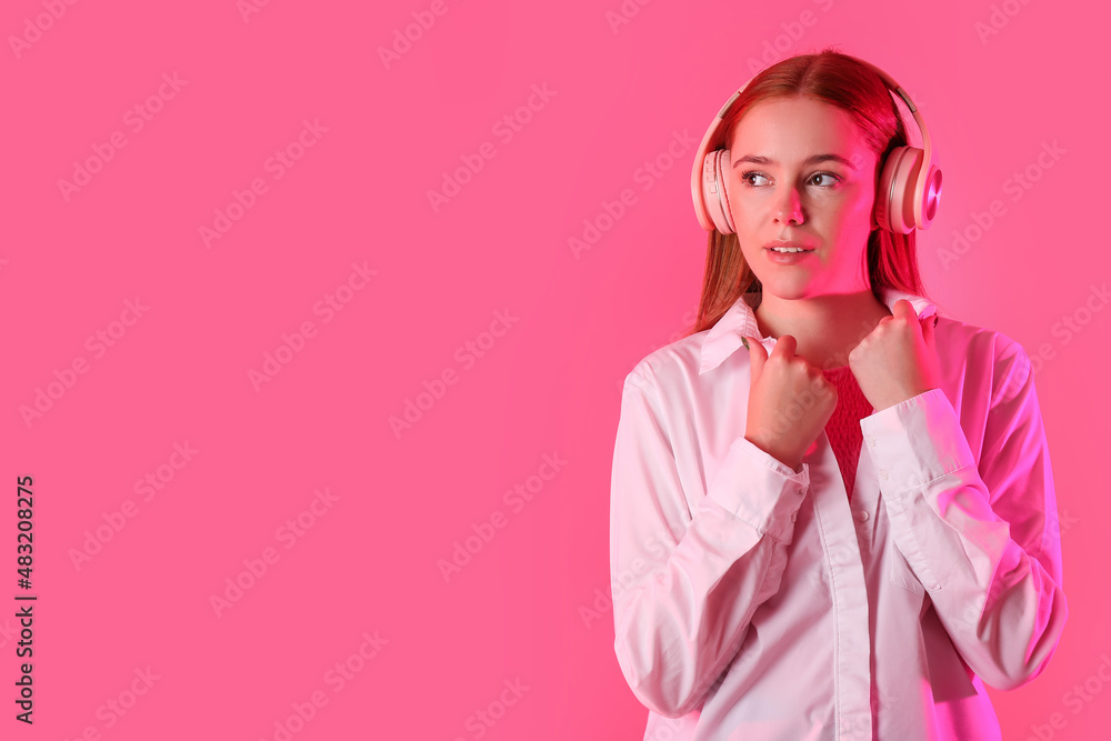 Cool young woman listening to music on color background