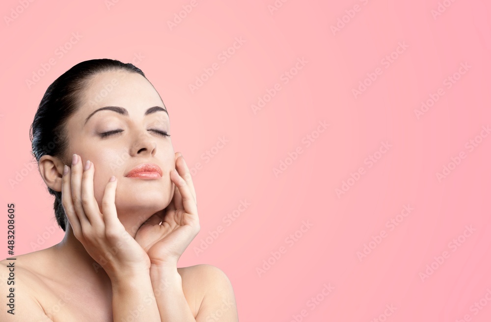 Photo of attractive happy young woman hold hands face cheeks