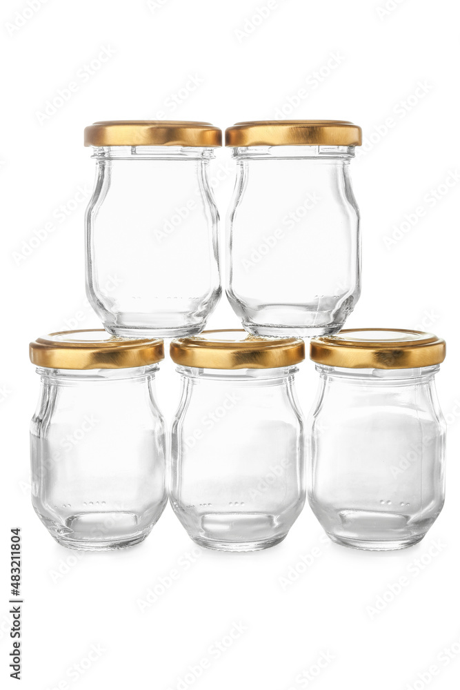 Empty glass jars with golden caps on white background