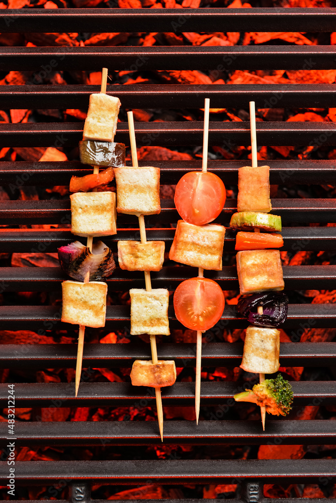 Skewers with tasty tofu cheese and vegetables on grill