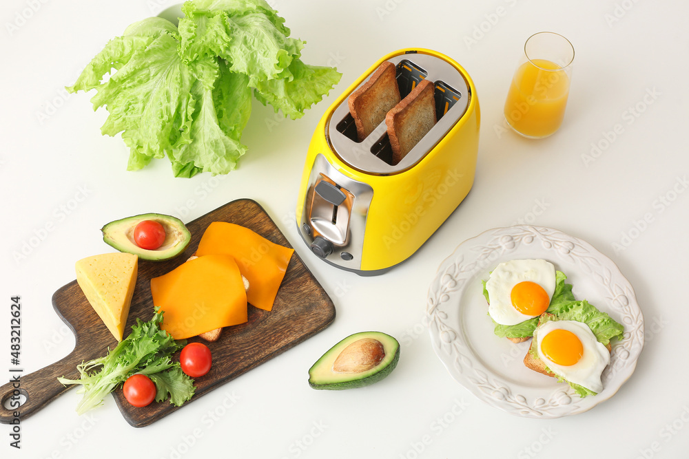 Yellow toaster with healthy food on white table