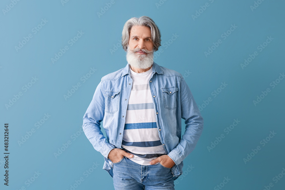 Bearded senior man on grey background