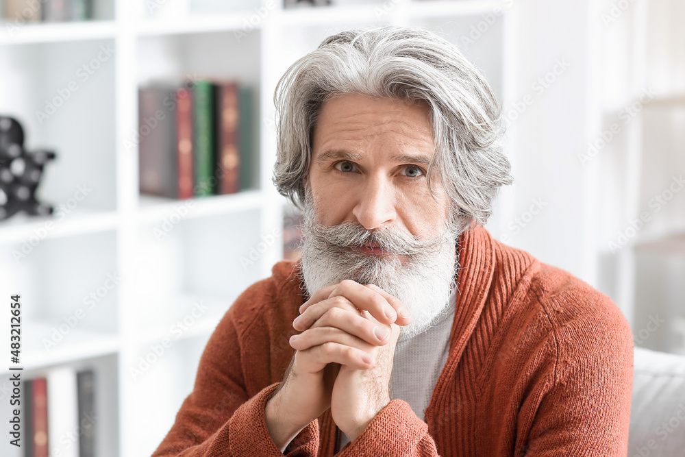 Thoughtful senior man at home, closeup