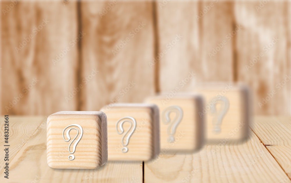 wooden blocks with a question mark. frequently asked questions marketing plan for educational ideas