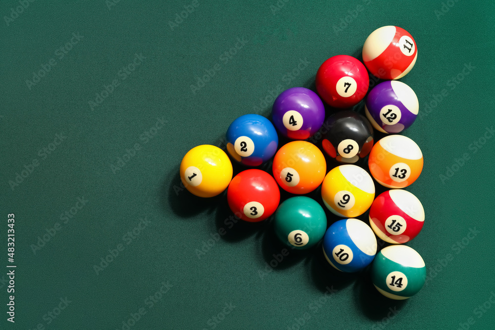 Different billiard balls on green table