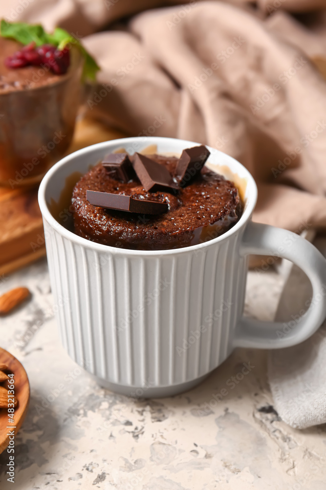 Cup with tasty chocolate brownie on table