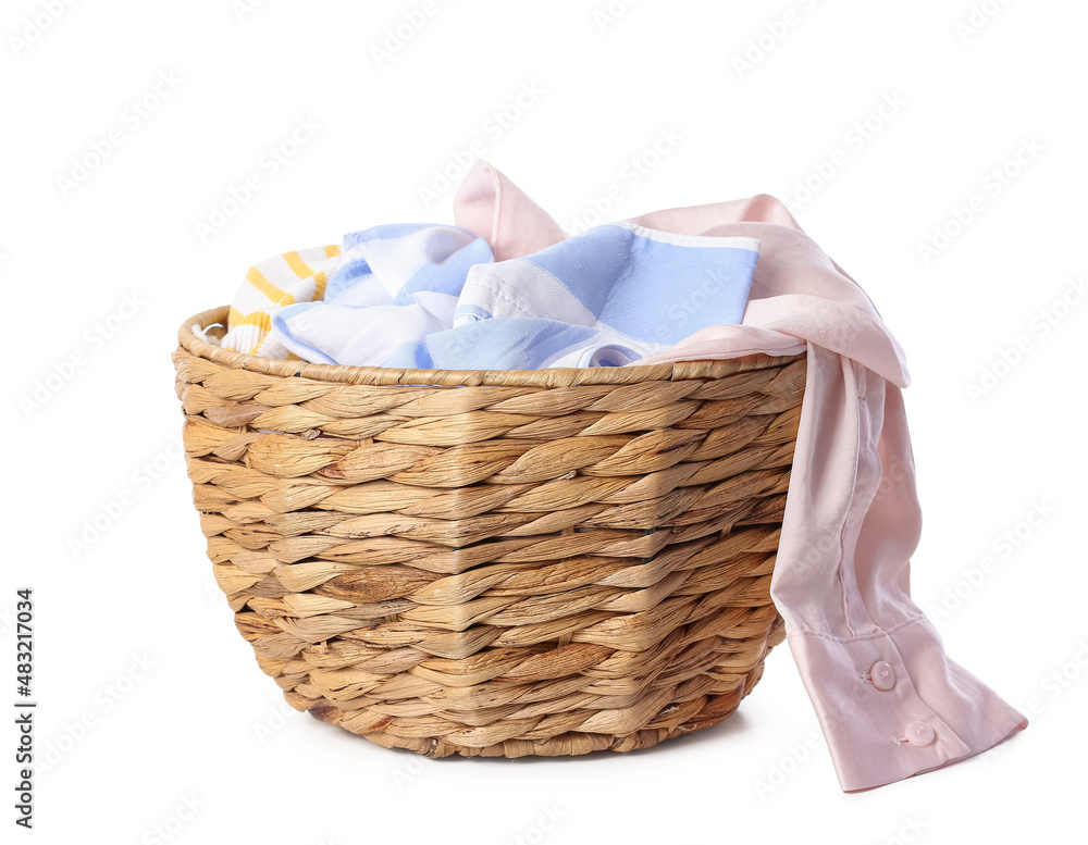 Wicker basket with different clothes on white background