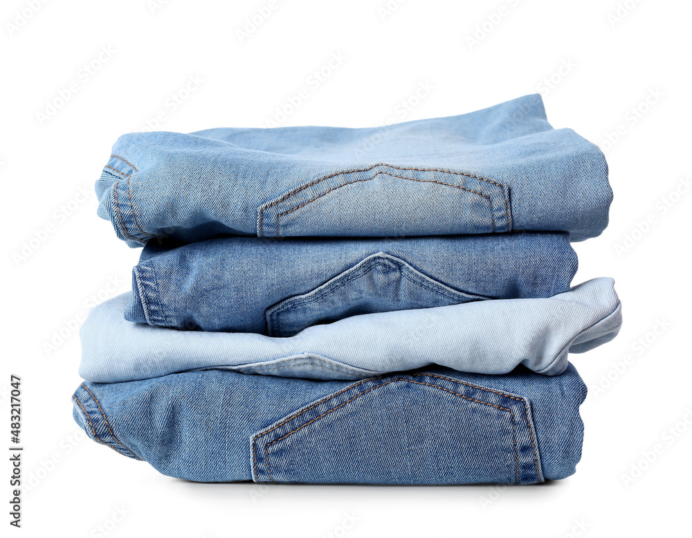 Stack of female jeans on white background