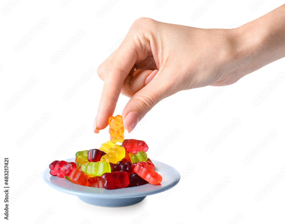 Woman eating tasty jelly bears on white background