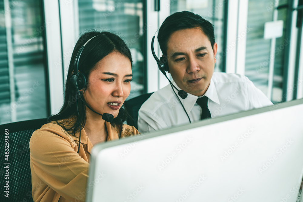 Business people wearing headset working actively in office . Call center, telemarketing, customer su