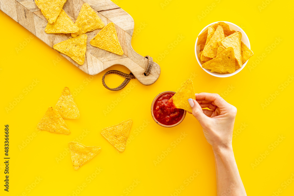 Mexican food nachos chips with tomato salsa sauce, top view