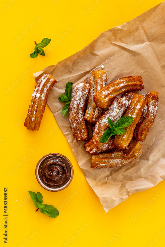 Treat churros with sugar served on baking paper