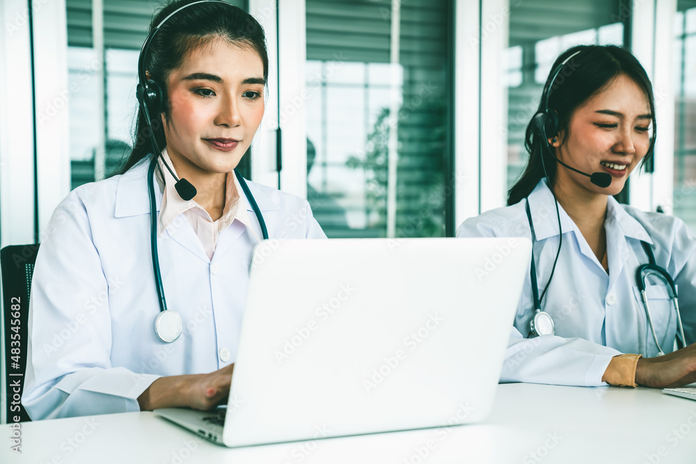 Doctor wearing headset talking actively on video call in hospital or clinic . Concept of telehealth 