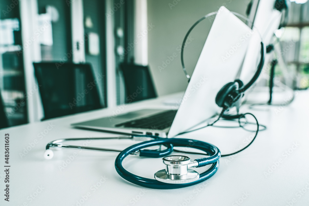 Headset and doctor equipment at clinic ready for actively support for patient by online video call .