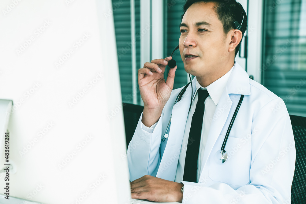 Doctor wearing headset talking actively on video call in a clinic or hospital . Concept of telehealt