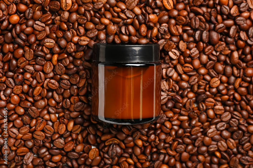 Cosmetic jar on coffee beans background